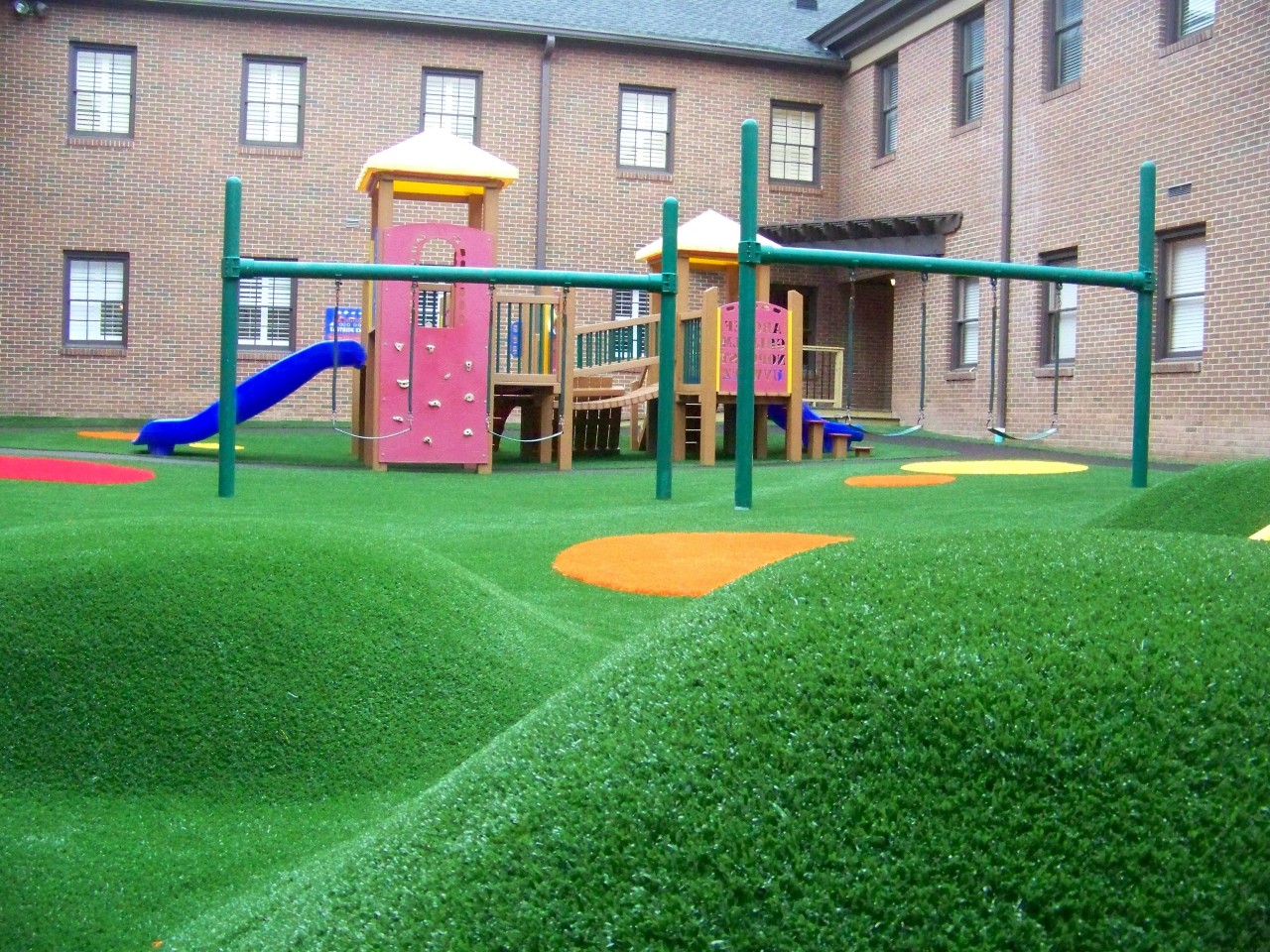 Hilly artificial turf playground by Southwest Greens of Austin